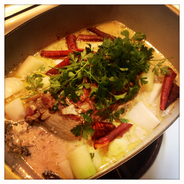 After the meat has been cooking for awhile in the milk, drop the vegies and parsley in