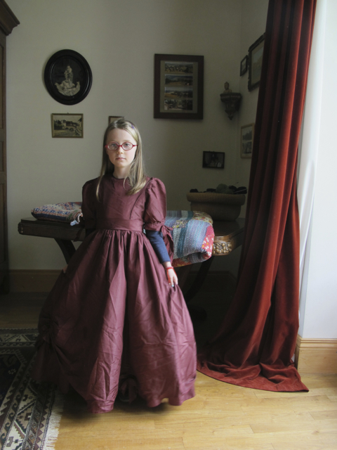 a little girl in an old dress